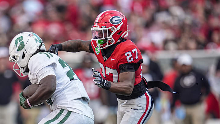 Nov 22, 2025; Athens, Georgia, USA; Georgia Bulldogs defensive back Rasean Dinkins (27) tries to tackle a Charlotte 49ers runner during the second half at Sanford Stadium. Mandatory Credit: Dale Zanine-Imagn Images