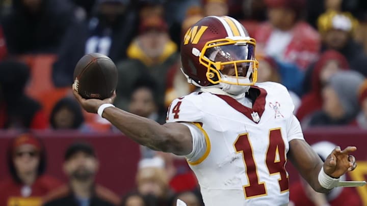 Washington Commanders quarterback Josh Johnson passes under pressure from Dallas Cowboys defensive end Donovan Ezeiruaku