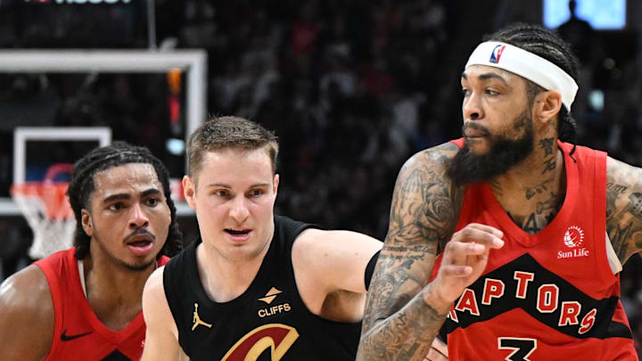 Toronto Raptors forward Brandon Ingram dribbles the ball past Cleveland Cavaliers guard Sam Merrill.