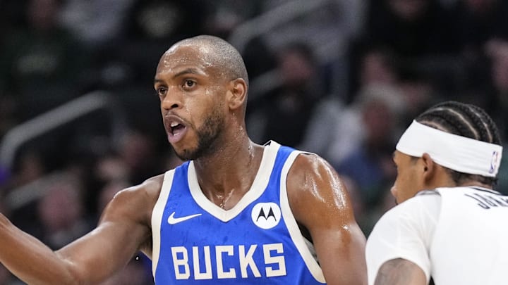 Dec 26, 2024; Milwaukee, Wisconsin, USA;  Milwaukee Bucks forward Khris Middleton (22) passes the ball as Brooklyn Nets guard Keon Johnson (45) defends during the first quarter at Fiserv Forum. Mandatory Credit: Jeff Hanisch-Imagn Images