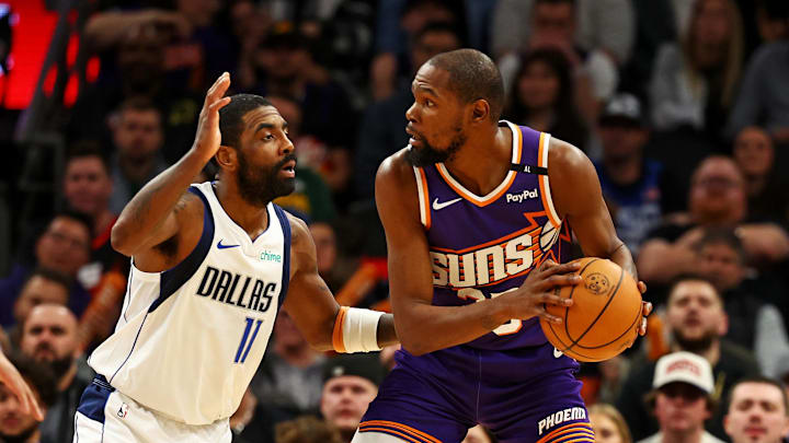 Dec 27, 2024; Phoenix, Arizona, USA; Phoenix Suns forward Kevin Durant (35) handles the ball against Dallas Mavericks guard Kyrie Irving (11) during the third quarter at Footprint Center. Mandatory Credit: Mark J. Rebilas-Imagn Images