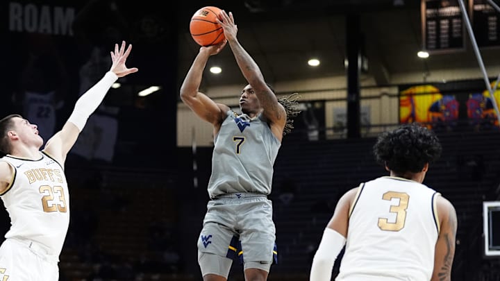 Jan 12, 2025; Boulder, Colorado, USA; West Virginia Mountaineers guard Javon Small (7) shoots the ball over Colorado Buffaloes forward Andrej Jakimovski (23) in the first half at CU Events Center. 