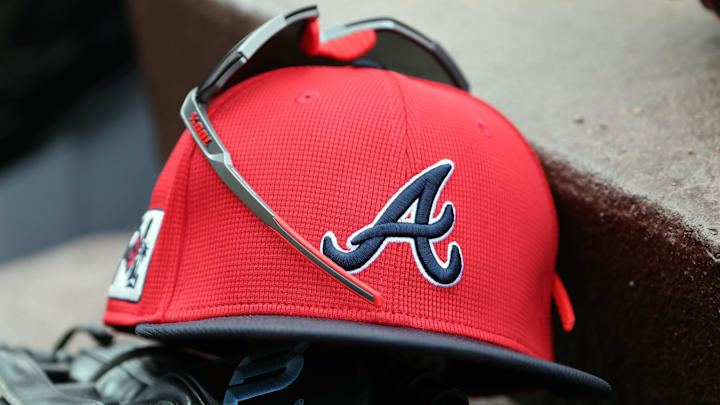 wMar 1, 2025; North Port, Florida, USA; A detail view of Atlanta Braves hat, sunglasses and glove in the dugout during the fifth inning at CoolToday Park. Mandatory Credit: Kim Klement Neitzel-Imagn Images