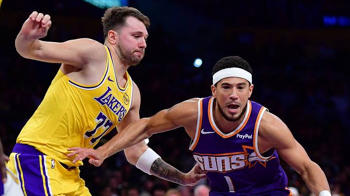 Dec 1, 2025; Los Angeles, California, USA; Phoenix Suns guard Devin Booker (1) moves to the basket against Los Angeles Lakers guard Luka Doncic (77) during the first half at Crypto.com Arena. Mandatory Credit: Gary A. Vasquez-Imagn Images Dec 1, 2025; Los Angeles, California, USA; Phoenix Suns guard Devin Booker (1) moves to the basket against Los Angeles Lakers guard Luka Doncic (77) during the first half at Crypto.com Arena. Mandatory Credit: Gary A. Vasquez-Imagn Images