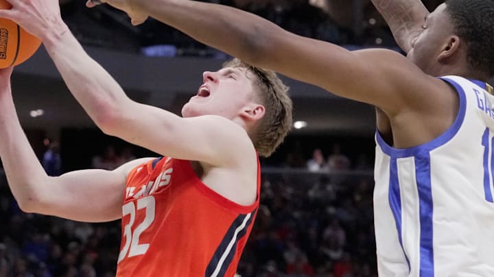 Illinois guard Kasparas Jakucionis (32) scores on Kentucky forward Brandon Garrison (10) during the second half of their second round NCAA men’ s basketball tournament game Sunday, March 23, 2025 at Fiserv Forum in Milwaukee, Wisconsin. Kentucky beat Illinois 84-75.