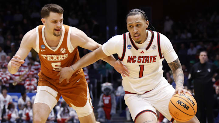 Mar 17, 2026; Dayton, OH, USA; NC State Wolfpack forward Darrion Williams (1) dribbles defended by Texas Longhorns forward Camden Heide (5) in the first half  during a first four game of the men's 2026 NCAA Tournament at University of Dayton Arena. Mandatory Credit: Rick Osentoski-Imagn Images
