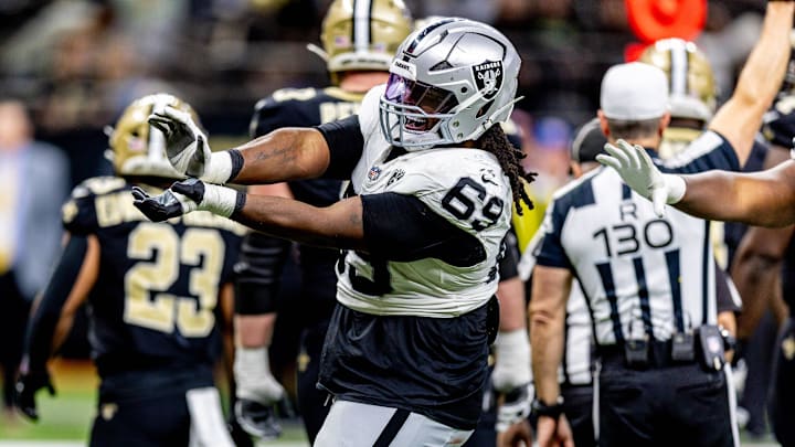 Dec 29, 2024; New Orleans, Louisiana, USA;  Las Vegas Raiders defensive tackle Adam Butler (69) reacts to making a third down stop against New Orleans Saints quarterback Spencer Rattler (18) during the second half at Caesars Superdome. Mandatory Credit: Stephen Lew-Imagn Images
