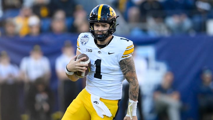 Dec 30, 2024; Nashville, TN, USA;  Iowa Hawkeyes quarterback Brendan Sullivan (1) scrambles against the Missouri Tigers during the first half at Nissan Stadium. Mandatory Credit: Steve Roberts-Imagn Images