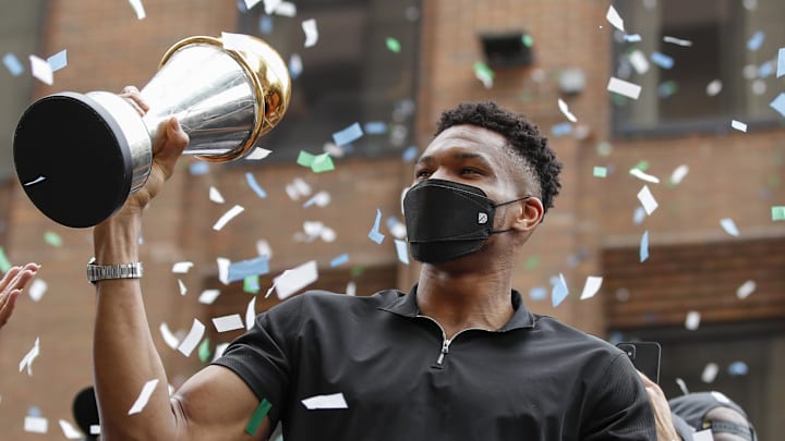 Jul 22, 2021; Milwaukee, WI, USA; Milwaukee Bucks forward Giannis Antetokounmpo (34) holds his NBA Finals MVP Trophy during the Milwaukee Bucks victory parade. Mandatory Credit: Kamil Krzaczynski-Imagn Images