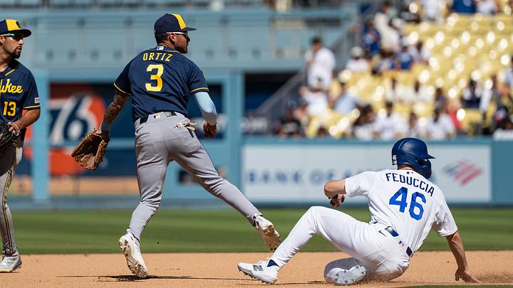 Milwaukee Brewers shortstop Joey Ortiz turns a double play against a sliding Los Angeles Dodgers catcher Hunter Feduccia. Milwaukee Brewers shortstop Joey Ortiz turns a double play against a sliding Los Angeles Dodgers catcher Hunter Feduccia.