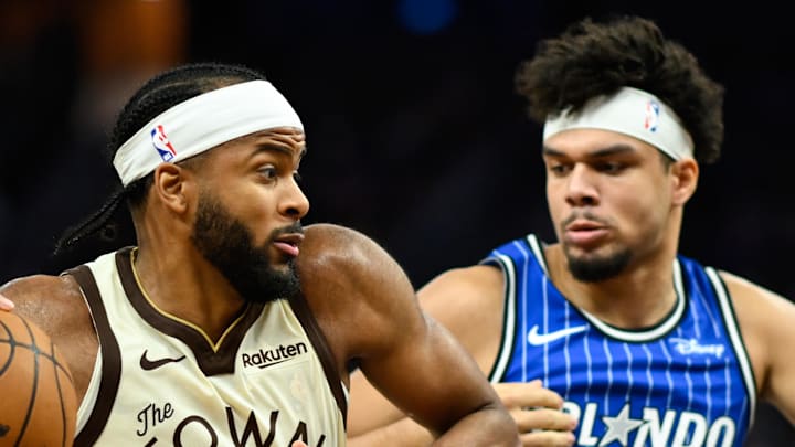 Golden State Warriors guard Moses Moody drives to the basket against Orlando Magic forward Noah Penda.