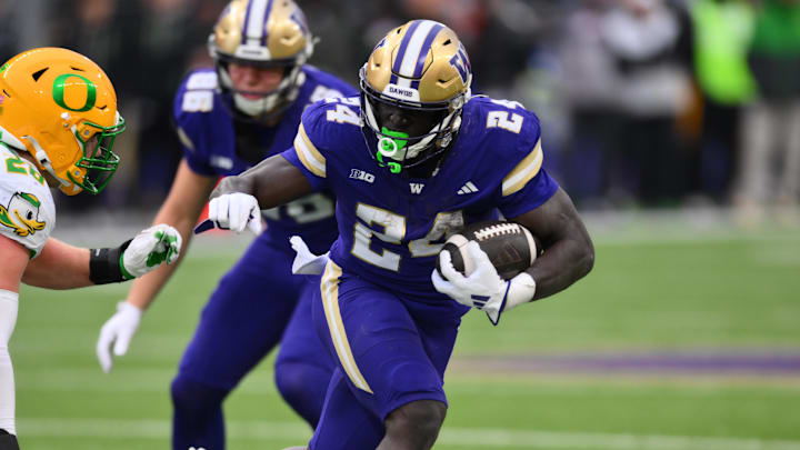Nov 29, 2025; Seattle, Washington, USA; Washington Huskies running back Adam Mohammed (24) carries the ball against the Oregon Ducks during the second half at Husky Stadium. Mandatory Credit: Steven Bisig-Imagn Images