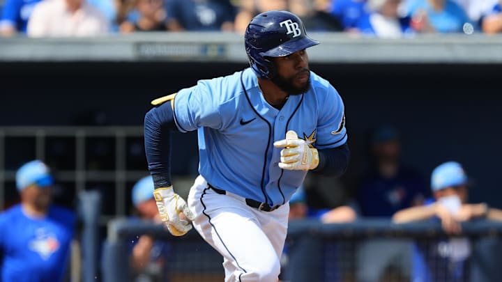 Feb 27, 2026; Port Charlotte, Florida, USA; Tampa Bay Rays center fielder Cedric Mullins (31) hits an sacrifice fly to score a run during the first inning against the Toronto Blue Jays at Charlotte Sports Park. 