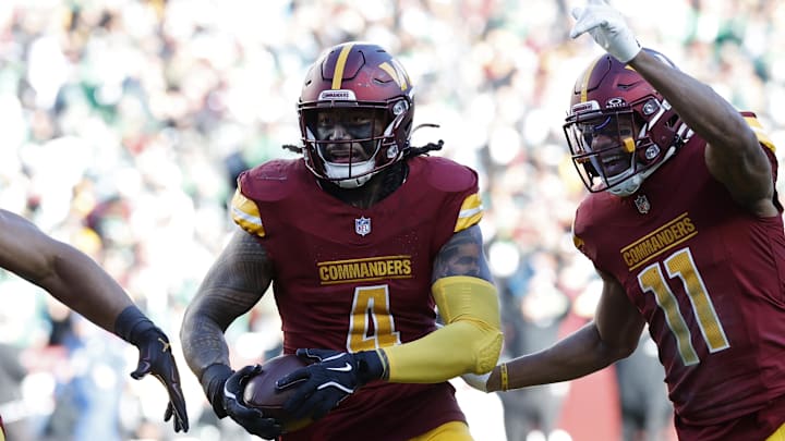 Dec 22, 2024; Landover, Maryland, USA; Washington Commanders linebacker Frankie Luvu (4) celebrates with teammates after intercepting a pass against the Philadelphia Eagles during the first quarter at Northwest Stadium. Mandatory Credit: Geoff Burke-Imagn Images