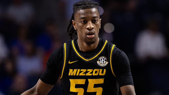 Feb 28, 2024; Gainesville, Florida, USA; Missouri Tigers guard Sean East II (55) dribbles the ball up the court towards Florida Gators guard Zyon Pullin (0) during the first half at Exactech Arena at the Stephen C. O'Connell Center. Mandatory Credit: Matt Pendleton-Imagn Images
