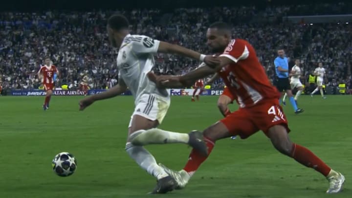 Jonathan Tah (right) caught Mbappé high on the calf.