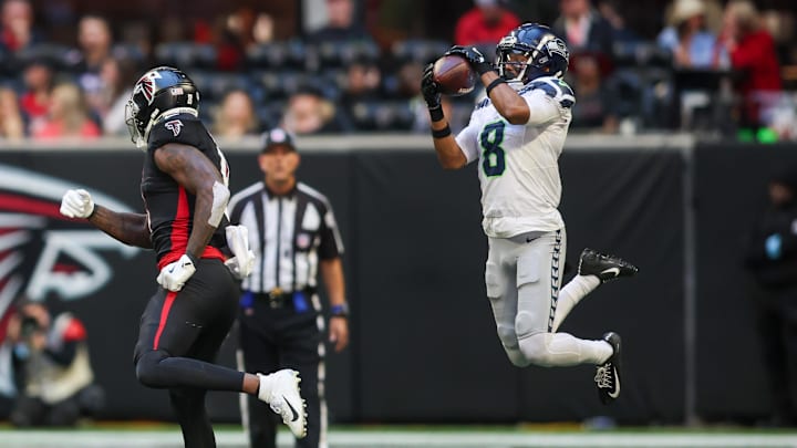 Oct 20, 2024; Atlanta, Georgia, USA; Seattle Seahawks cornerback Coby Bryant (8) intercepts a pass intended for Atlanta Falcons tight end Kyle Pitts (8) in the fourth quarter at Mercedes-Benz Stadium.