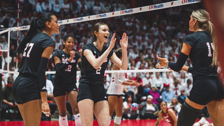 Nebraska volleyball players celebrate a point at Wisconsin.