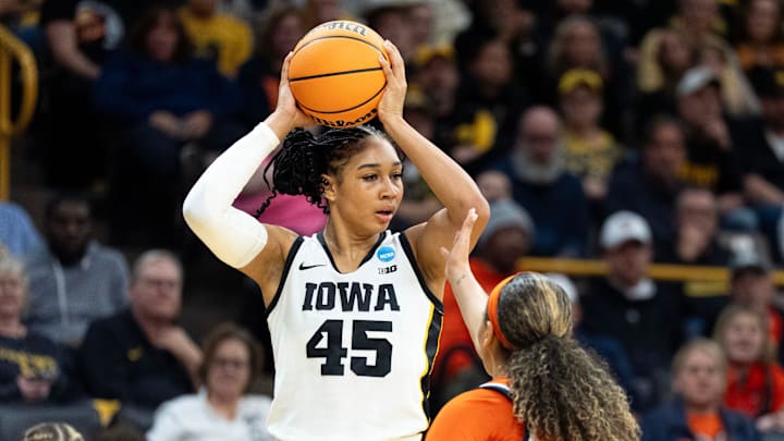 Iowa forward Hannah Stuelke (45) looks to pass the ball against Virginia guard Paris Clark (1) March 23, 2026 during a Round of 32 NCAA March Madness game at Carver-Hawkeye Arena in Iowa City, Iowa.