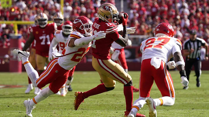 Oct 20, 2024; Santa Clara, California, USA; San Francisco 49ers wide receiver Brandon Aiyuk (11) catches a pass between Kansas City Chiefs cornerback Trent McDuffie (22) and safety Chamarri Conner (27) in the second quarter at Levi's Stadium. Mandatory Credit: Cary Edmondson-Imagn Images