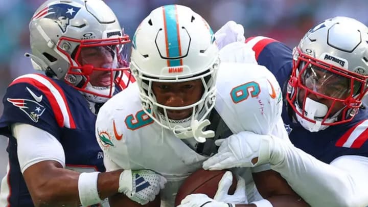 MIAMI GARDENS, FLORIDA - NOVEMBER 24: Jonnu Smith #9 of the Miami Dolphins carries the ball against the New England Patriots during the first half at Hard Rock Stadium on November 24, 2024 in Miami Gardens, Florida. Photo credit Megan Briggs/Getty Images