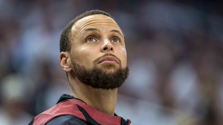 Golden State Warriors guard Stephen Curry looks on from the bench against the Minnesota Timberwolves.