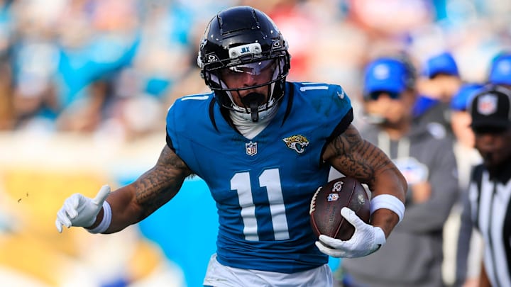 Jacksonville Jaguars wide receiver Parker Washington (11) tip toes the line as he is forced out of bounds by Buffalo Bills defensive end Joey Bosa (97) during the fourth quarter of an NFL football AFC Wild Card playoff matchup, Sunday, Jan. 11, 2026, in Jacksonville, Fla. The Bills defeated the Jaguars 27-24. [Corey Perrine/Florida Times-Union]