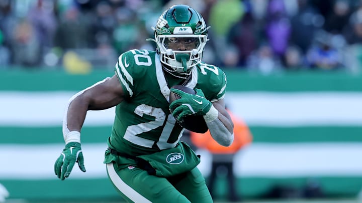 Dec 22, 2024; East Rutherford, New Jersey, USA; New York Jets running back Breece Hall (20) runs with the ball against the Los Angeles Rams during the second quarter at MetLife Stadium. Mandatory Credit: Brad Penner-Imagn Images
