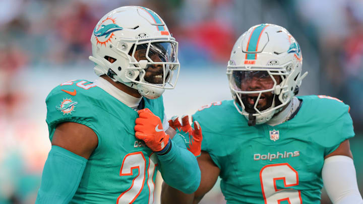 Miami Dolphins linebacker Jordyn Brooks celebrates with linebacker Anthony Walker Jr. after sacking Brock Purdy.