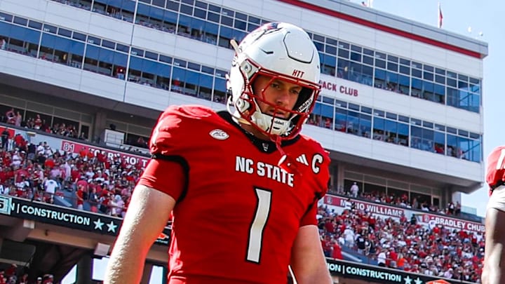 Oct 4, 2025; Raleigh, North Carolina, USA; NC State Wolfpack quarterback CJ Bailey (11), linebacker Caden Fordham (1), wide receiver Keenan Jackson (8) and offensive lineman Jr. Anthony Carter (75) walk out for the coin toss prior to the first half of the game against Campbell Fighting Camels at Carter-Finley Stadium. Mandatory Credit: Jaylynn Nash-Imagn Images