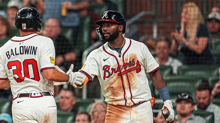May 13, 2025; Cumberland, Georgia, USA; Atlanta Braves catcher Drake Baldwin (30) reacts with center fielder Michael Harris II (23) after scoring a run against the Washington Nationals during the eighth inning at Truist Park. Mandatory Credit: Dale Zanine-Imagn Images