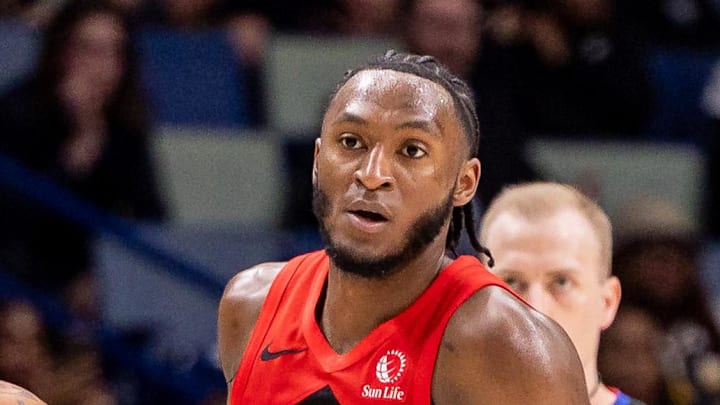 Toronto Raptors guard Immanuel Quickley brings the ball up court against New Orleans Pelicans guard Dejounte Murray.