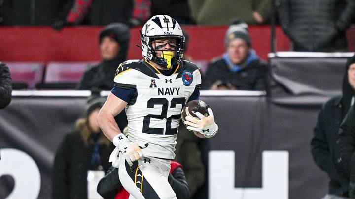 Dec 14, 2024; Landover, Maryland, USA; Navy Midshipmen running back Eli Heidenreich (22) runs for a third quarter touchdown against the Army Black Knights  at Commanders Field. Mandatory Credit: Tommy Gilligan-Imagn Images