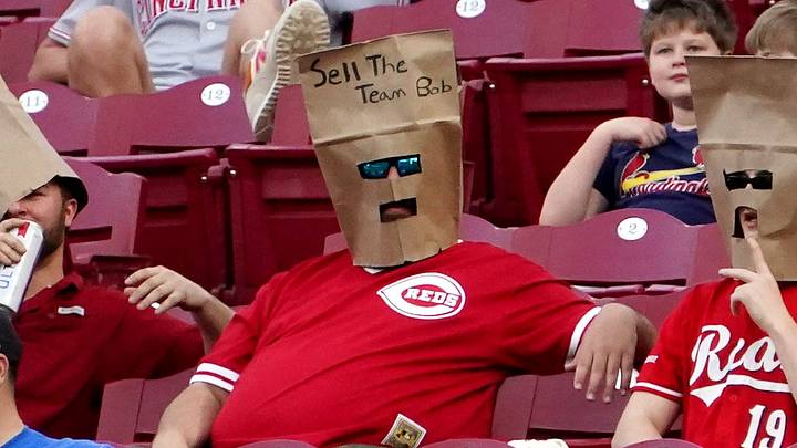Cincinnati Reds fans wear paper bags on their heads
