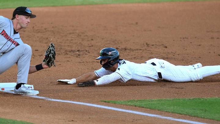 Augusta GreenJacket infielder Tate Southisene (7) slides into third base as Fayetteville infielder Xavier Neyens (9) defends during opening day of the Augusta GreenJackets at SRP Park in North Augusta, S.C., on Tuesday, April 14, 2026. The GreenJackets beat Fayetteville 4-2. Mandatory Credit: Katie Goodale - Augusta Chronicle/USA TODAY NETWORK