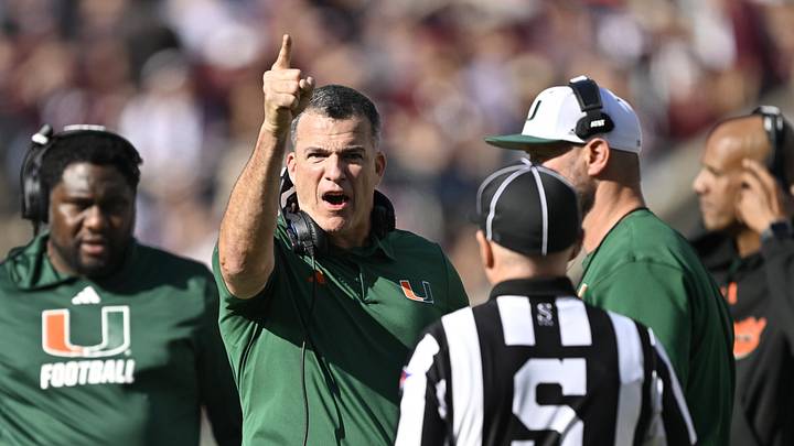 Dec 20, 2025; College Station, TX, USA; Miami Hurricanes head coach Mario Cristobal talks with an official during the second half of the first round game of the CFP National Playoff against the Texas A&M Aggies at Kyle Field. Mandatory Credit: Jerome Miron-Imagn Images