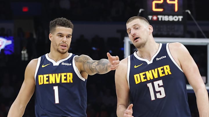 Mar 10, 2025; Oklahoma City, Oklahoma, USA; Denver Nuggets forward Michael Porter Jr. (1) and center Nikola Jokic (15) talk during a time out against the Oklahoma City Thunder during the second half at Paycom Center. Mandatory Credit: Alonzo Adams-Imagn Images