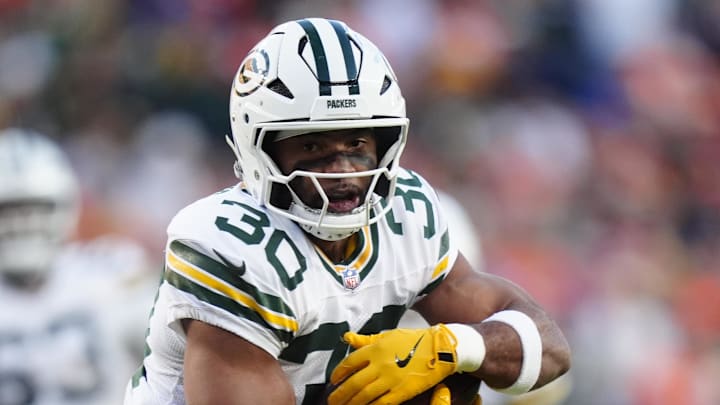 Green Bay Packers running back Chris Brooks (30) runs for with the ball against the Broncos. Green Bay Packers running back Chris Brooks (30) runs for with the ball against the Broncos.