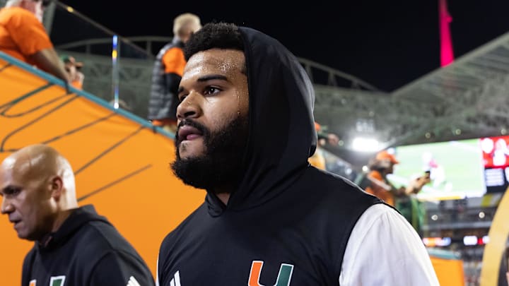 Jan 19, 2026; Miami Gardens, FL, USA; Miami Hurricanes defensive lineman Akheem Mesidor (3) with coach Jason Taylor against the Indiana Hoosiers during the College Football Playoff National Championship game at Hard Rock Stadium. Mandatory Credit: Mark J. Rebilas-Imagn Images