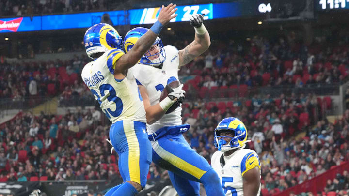 Oct 19, 2025; London, United Kingdom; Los Angeles Rams tight end Terrance Ferguson (18) celebrates with running back Kyren Williams (23) as wide receiver Konata Mumpfield (15) watches after scoring on a 31-yard touchdown reception in the fourth quarter against the Jacksonville Jaguars during a NFL International Series game at Wembley Stadium. Mandatory Credit: Kirby Lee-Imagn Images