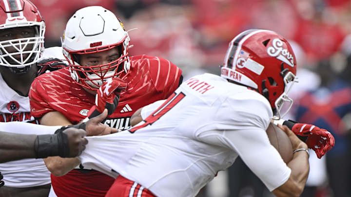 Aug 31, 2024; Louisville, Kentucky, USA; Louisville Cardinals defensive lineman Thor Griffith (50) sacks Austin Peay Governors quarterback Austin Smith (4) during the second half at L&N Federal Credit Union Stadium. Louisville defeated Austin Peay 62-0. Mandatory Credit: Jamie Rhodes-Imagn Images Aug 31, 2024; Louisville, Kentucky, USA; Louisville Cardinals defensive lineman Thor Griffith (50) sacks Austin Peay Governors quarterback Austin Smith (4) during the second half at L&N Federal Credit Union Stadium. Louisville defeated Austin Peay 62-0. Mandatory Credit: Jamie Rhodes-Imagn Images