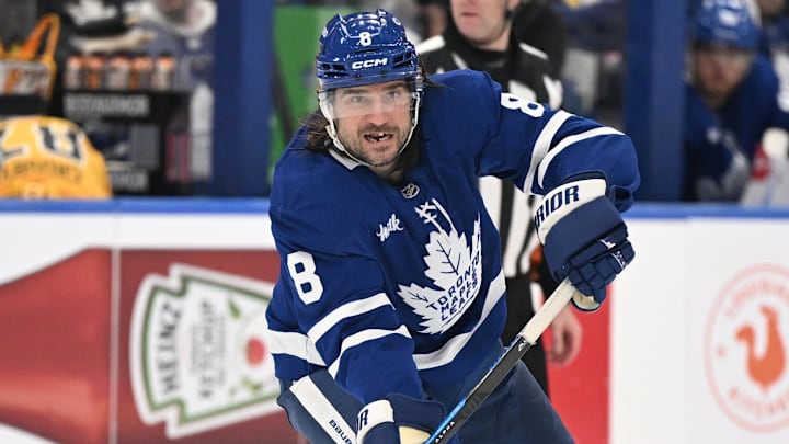 Dec 23, 2025; Toronto, Ontario, CAN;  Toronto Maple Leafs defenseman Chris Tanev (8) passes the puck against the Pittsburgh Penguins in the third period at Scotiabank Arena. Mandatory Credit: Dan Hamilton-Imagn Images