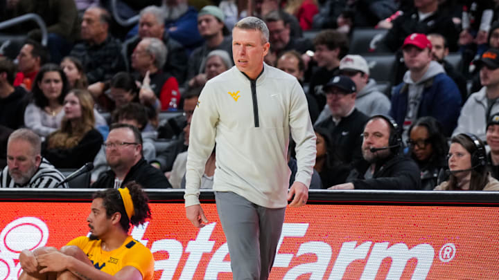 Feb 5, 2026; Cincinnati, Ohio, USA;  West Virginia Mountaineers head coach Ross Hodge works the sideline against the Cincinnati Bearcats in the first half at Fifth Third Arena. 
