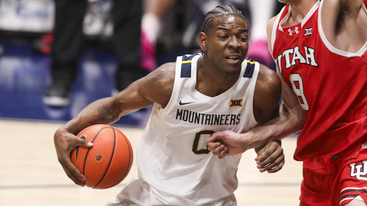 Feb 18, 2026; Morgantown, West Virginia, USA; West Virginia Mountaineers forward Brenen Lorient (0) drives down the lane against Utah Utes forward Keanu Dawes (8) during the first half at Hope Coliseum. Mandatory Credit: Ben Queen-Imagn Images