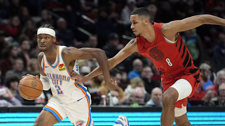 Mar 6, 2024; Portland, Oregon, USA; Oklahoma City Thunder point guard Shai Gilgeous-Alexander (2) dribbles the ball on a fast break against Portland Trail Blazers forward Kris Murray (8) during the second half at Moda Center. Mandatory Credit: Soobum Im-Imagn Images