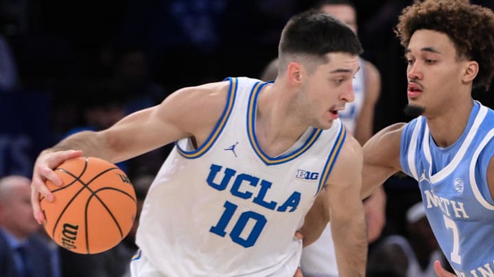 Dec 21, 2024; New York, NY, USA; UCLA Bruins guard Lazar Stefanovic (10) tries to get past North Carolina Tar Heels guard Seth Trimble (7) during the second half at Madison Square Garden. Mandatory Credit: John Jones-Imagn Images