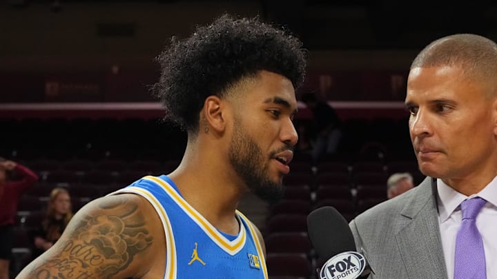 Mar 7, 2026; Los Angeles, California, USA; FS1 analyst Miles Simon (right) interviews UCLA Bruins guard Donovan Dent (2) after the game against the Southern California Trojans at the Galen Center. Mandatory Credit: Kirby Lee-Imagn Images