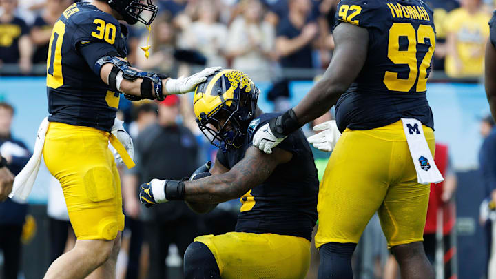 Michigan Wolverines defensive end Derrick Moore (8) reacts with Michigan Wolverines linebacker Jimmy Rolder (30) Michigan Wolverines defensive end Derrick Moore (8) reacts with Michigan Wolverines linebacker Jimmy Rolder (30)