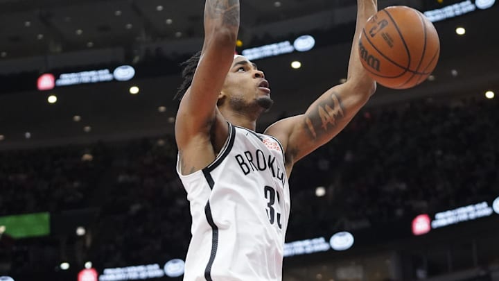 Mar 13, 2025; Chicago, Illinois, USA; Brooklyn Nets center Nic Claxton (33) dunks the ball on Chicago Bulls guard Coby White (0) during the second half at United Center. Mandatory Credit: David Banks-Imagn Images