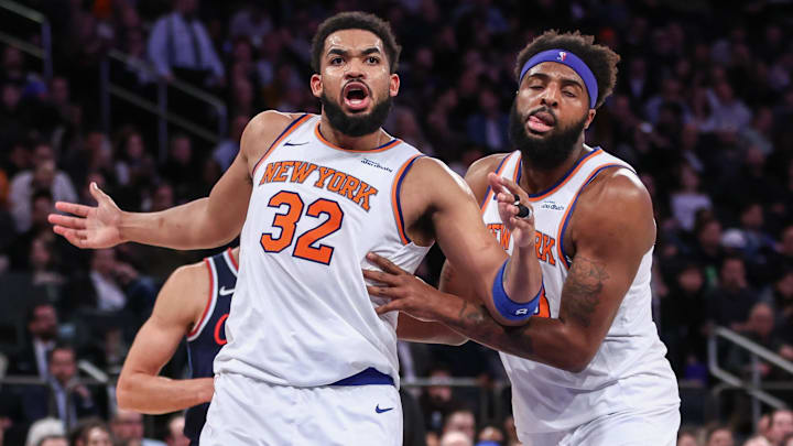 Mar 26, 2025; New York, New York, USA;  New York Knicks center Karl-Anthony Towns (32) is restrained by center Mitchell Robinson (23) in the fourth quarter against the LA Clippers at Madison Square Garden. Mandatory Credit: Wendell Cruz-Imagn Images